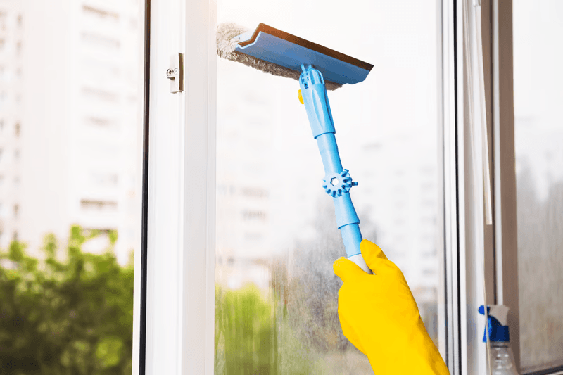 Streak-free window cleaning with a squeegee on a commercial storefront